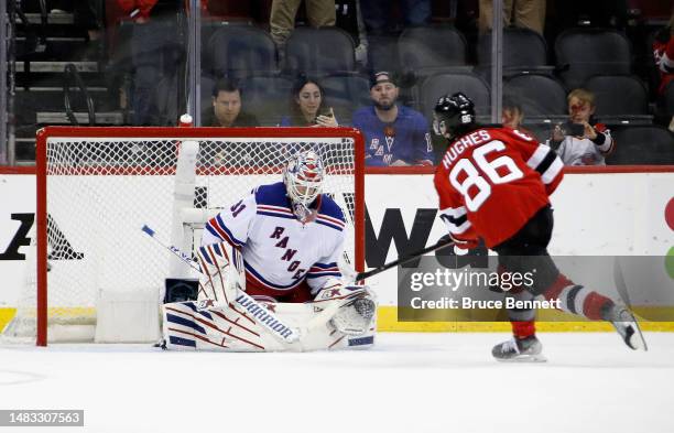 Jack Hughes of the New Jersey Devils scores against Igor Shesterkin of the New York Rangers on the third period penalty shot during Game One in the...