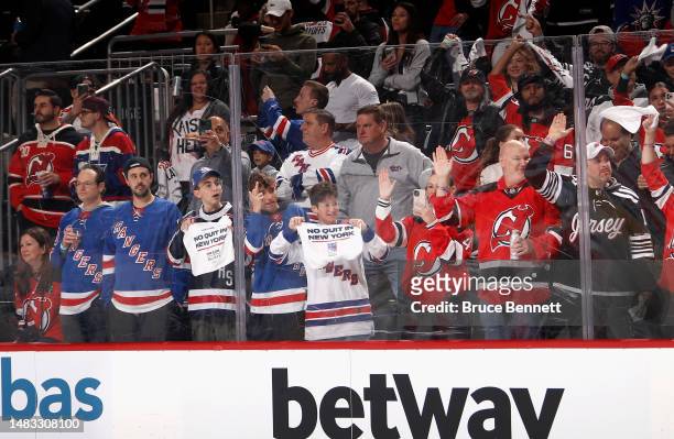 New Jersey Devils and New York Rangers fans watch warm-ups prior to Game One in the First Round of the 2023 Stanley Cup Playoffs at the Prudential...