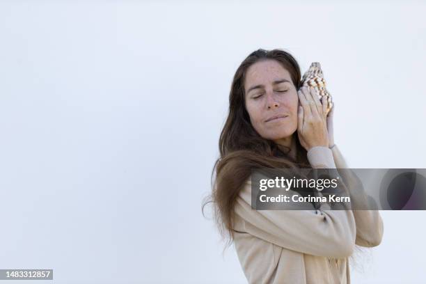 Listen Sea Shell Photos and Premium High Res Pictures - Getty Images