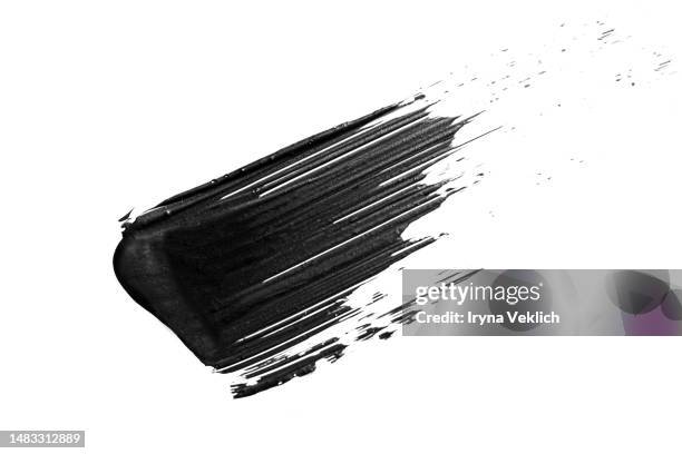 black smear mascara on white background, isolated. cosmetic make-up products for eyelashes. - smudged stockfoto's en -beelden