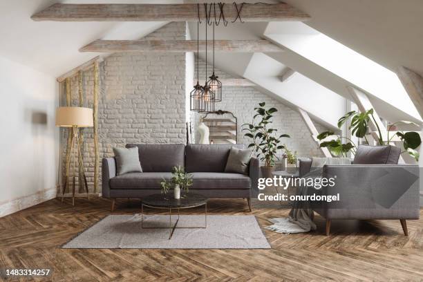 modernes wohnzimmer mit sofa, sessel, couchtisch und zimmerpflanzen im dachgeschoss. - dachgeschoß stock-fotos und bilder