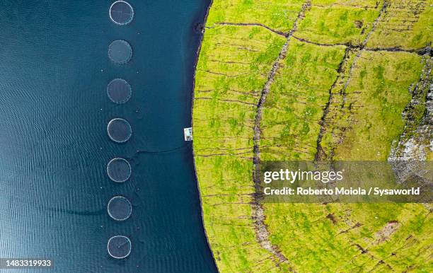 aerial view of fishing tanks along the fjord - aquaculture stock pictures, royalty-free photos & images