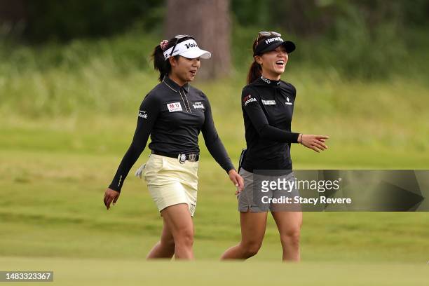 Mi Hyang Lee of South Korea and Lydia Ko of New Zealand walk down the 18th fairway during a practice round prior to The Chevron Championship at The...