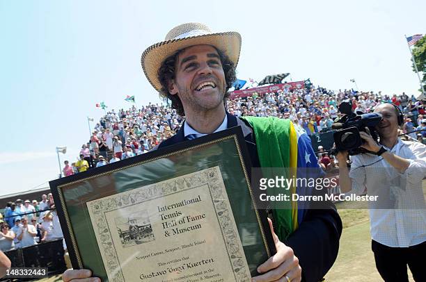 Guga Kuerten holds his plaque after being inducted into the International Tennis Hall Of Fame July 14, 2012 in Newport, Rhode Island. Inducted this...