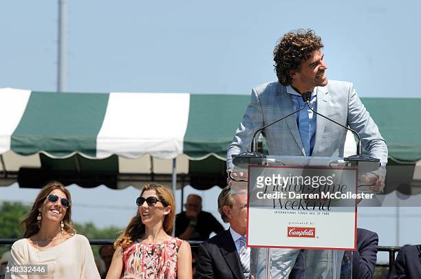 Guga Kuerten gives his speech while being inducted in to the International Tennis Hall Of Fame as Jennifer Capriati and Monica Seles look on July 14,...