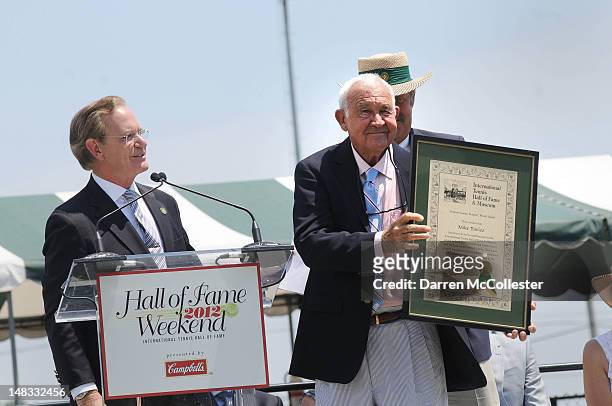 Mike Davies holds his plaque after being inducted into the International Tennis Hall Of Fame July 14, 2012 in Newport, Rhode Island. Inducted this...
