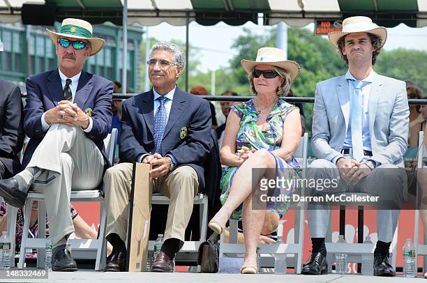 Stan Smith, Manuel Orantes, Alice Kuerten, and Guga Kuerten listen during the International Tennis Hall Of Fame induction ceremonies July 14, 2012 in...