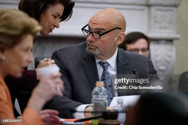 Sen. John Fetterman speaks with Sen. Amy Klobuchar while chairing a Senate Agriculture, Nutrition and Forestry subcommittee hearing to examine the...