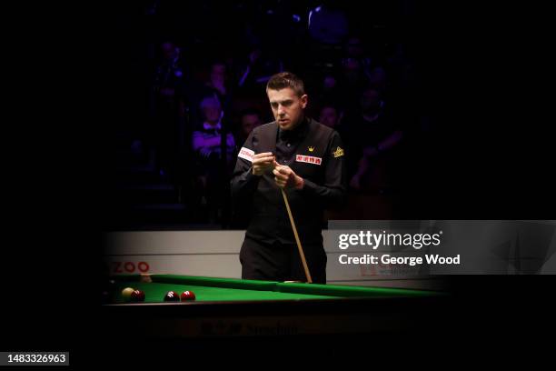 Mark Selby of England chalks the cue during their round one match against Matthew Selt of England on Day Five of the Cazoo World Snooker Championship...