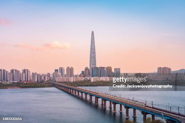 gyeonggi province bridge over river with buildings against sky, south korea - seul stock pictures, royalty-free photos & images