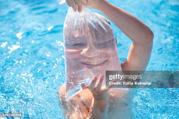 funny photo of a boy in the pool - actor swimming pool fotografías e imágenes de stock