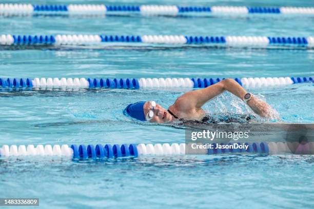 middle aged master's swimmer in pool - length stock pictures, royalty-free photos & images