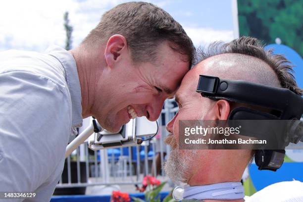 Former NFL safety Steve Gleason is hugged by his former teammate quarterback Drew Brees during the pro-am prior to the Zurich Classic of New Orleans...