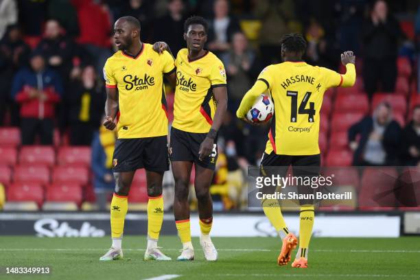 Ismaila Sarr of Watford celebrates with teammates Keinan Davis and Hassane Kamara after scoring the team's first goal during the Sky Bet Championship...