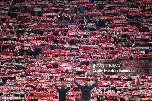 Fans of FC Bayern Munich hold aloft scarves prior to the UEFA Champions League quarterfinal second leg match between FC Bayern München and Manchester...