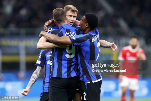 Nicolo Barella of FC Internazionale celebrates with teammate Edin Dzeko and Denzel Dumfries after scoring the team's first goal during the UEFA...