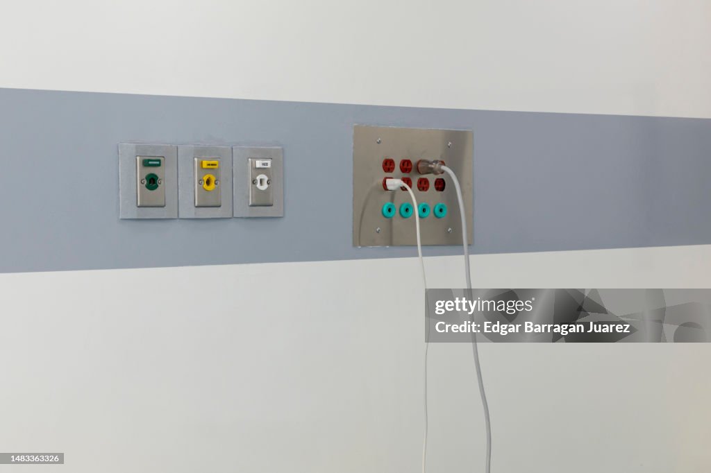 Oxygen outlet , medical air and vacuum outlet or connection on the wall of an operating room, with power outlets on the side
