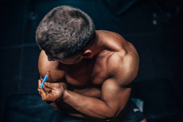 man injecting steroids - performance enhancing drugs stock pictures, royalty-free photos & images