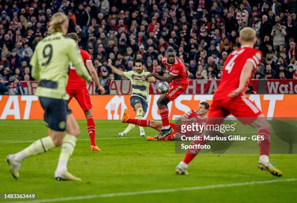 Ilkay Guendogan of Manchester shots Dayot Upamecano of Bayern at his arm for a penalty during the UEFA Champions League quarterfinal second leg match...