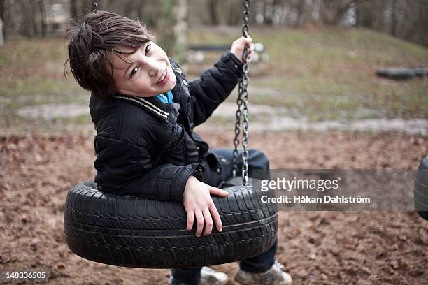 boy in swing - tire swing stock pictures, royalty-free photos & images