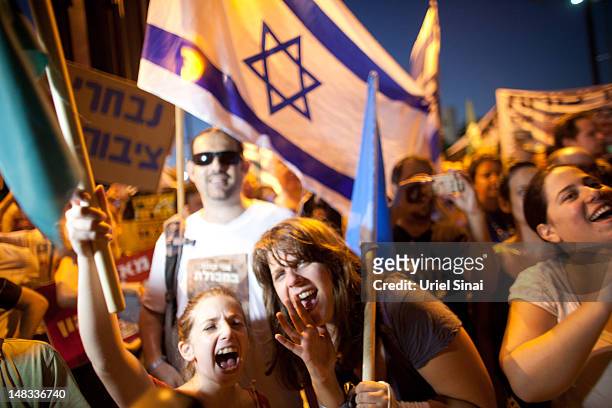 Demonstrators march through the streets to protest rising housing costs on July 14, 2012 in Tel Aviv, Israel. Growing discontent among Israelis over...