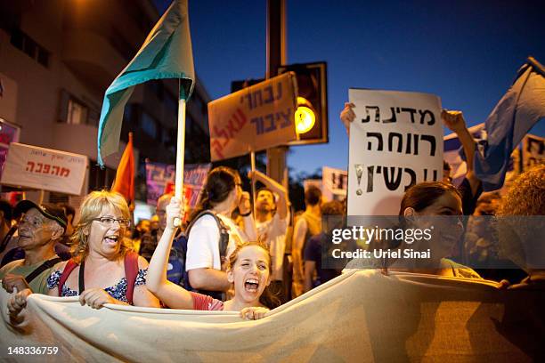 Demonstrators march through the streets to protest rising housing costs on July 14, 2012 in Tel Aviv, Israel. Growing discontent among Israelis over...