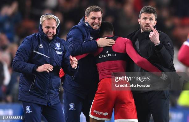 Middlesbrough player Chuba Akpom celebrates with head coach Michael Carrick and coach Jonathan Woodgate after scoring the third Boro goal during the...