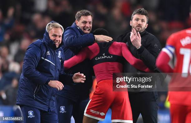 Middlesbrough player Chuba Akpom celebrates with head coach Michael Carrick and coach Jonathan Woodgate after scoring the third Boro goal during the...