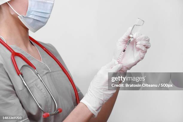 doctor,nurse or scientist hand in white medical gloves holding flu,measles,coronavirus vaccine shot for diseases outbreak vaccination,medicine and drug concept - measles hand stock pictures, royalty-free photos & images
