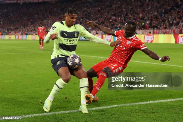 Manuel Akanji of Manchester City handles the ball whilst under pressure from Sadio Mane of FC Bayern Munich leading to a penalty being awarded after...