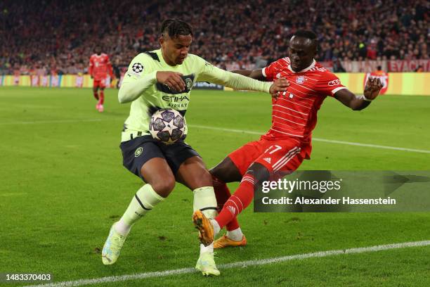 Manuel Akanji of Manchester City handles the ball whilst under pressure from Sadio Mane of FC Bayern Munich leading to a penalty being awarded after...