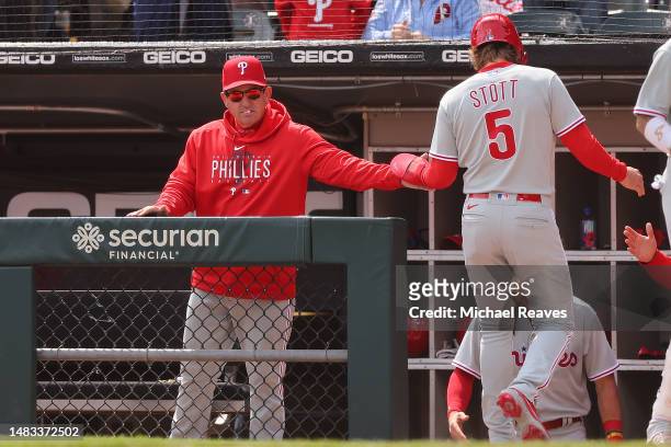 Manager Rob Thomson of the Philadelphia Phillies fist bumps Bryson Stott after he scored a run against the Chicago White Sox during the fourth inning...
