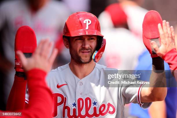 Trea Turner of the Philadelphia Phillies high fives teammates after scoring a run during the third inning against the Chicago White Sox at Guaranteed...