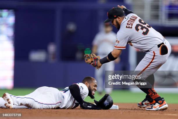 Bryan De La Cruz of the Miami Marlins slides at second base against Thairo Estrada of the San Francisco Giants during the fourth inning at loanDepot...