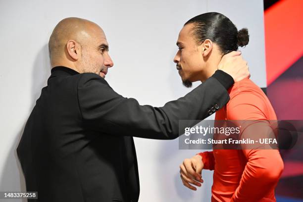 Leroy Sane of FC Bayern Munich is consoled in the tunnel by Pep Guardiola, Manager of Manchester City, after their side's elimination from the UEFA...