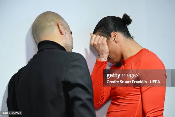 Leroy Sane of FC Bayern Munich is consoled in the tunnel by Pep Guardiola, Manager of Manchester City, after their side's elimination from the UEFA...