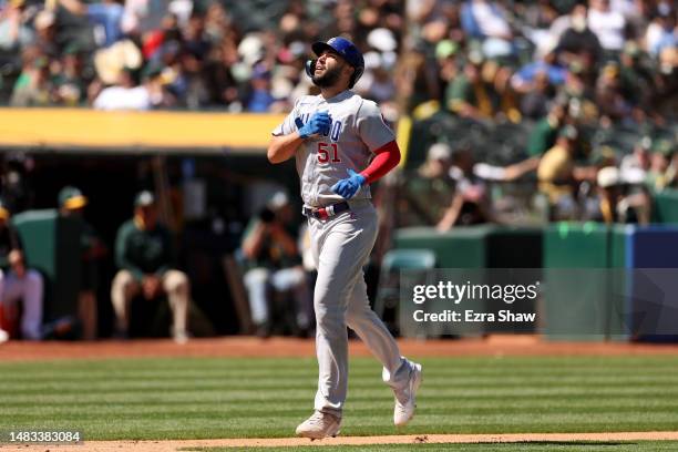 Eric Hosmer of the Chicago Cubs reacts as he crosses home plate after hitting a home run in the eighth inning against the Oakland Athletics at...