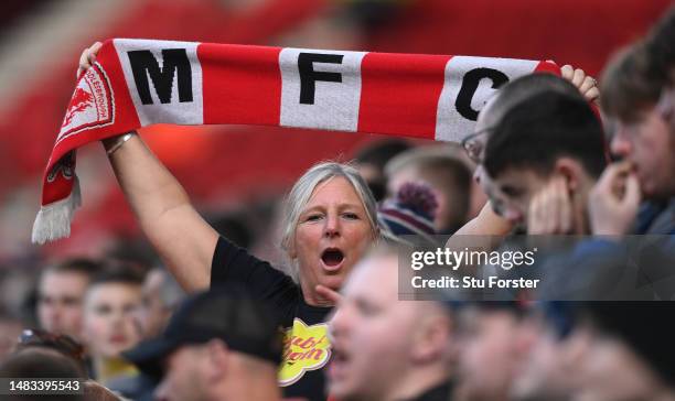 Female Middlesbrough fan with a MFC scarf looks on during the Sky Bet Championship between Middlesbrough and Hull City at Riverside Stadium on April...