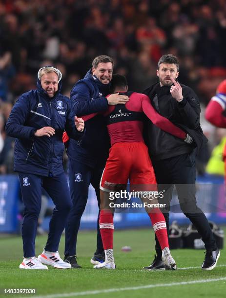 Middlesbrough player Chuba Akpom celebrates with head coach Michael Carrick and coach Jonathan Woodgate after scoring the third Boro goal during the...