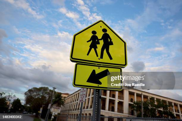 School crossing sign warns drivers in front of an elementary school on April 19, 2023 in Miami, Florida. The Florida Board of Education today...