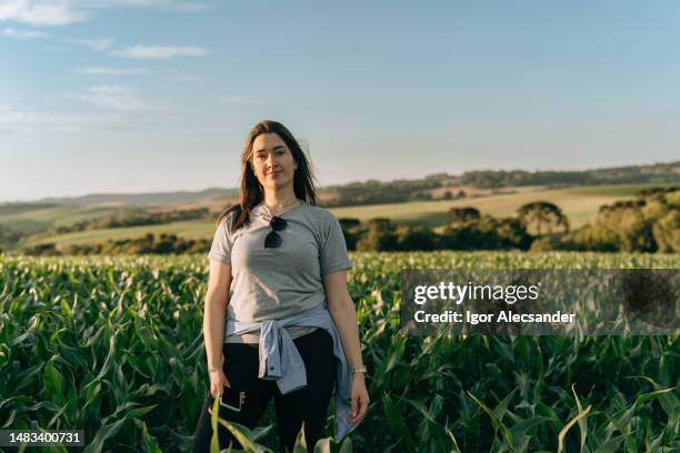 young female farmer in the corn field - rio grande rise stock pictures, royalty-free photos & images