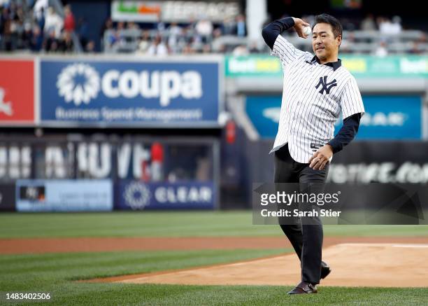 Former New York Yankees pitcher Hiroki Kuroda throws a ceremonial first pitch before the game against the Los Angeles Angels at Yankee Stadium on...