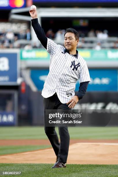 Former New York Yankees pitcher Hiroki Kuroda throws a ceremonial first pitch before the game against the Los Angeles Angels at Yankee Stadium on...