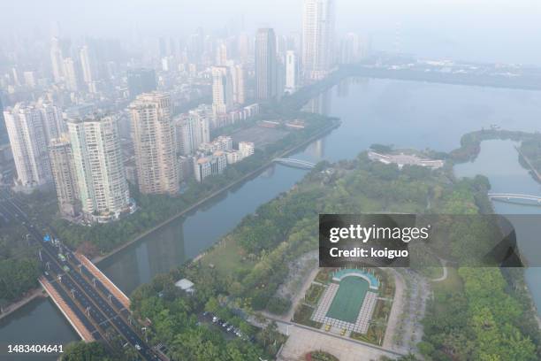 misty city park and buildings in the early morning - xiamen stock pictures, royalty-free photos & images