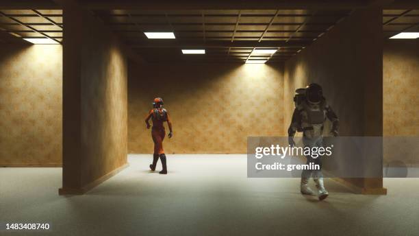 abstract image of astronauts walking in old derelict offices - walking past office wall stock pictures, royalty-free photos & images