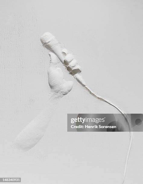 relief of hand with microphone - hand microphone stock pictures, royalty-free photos & images