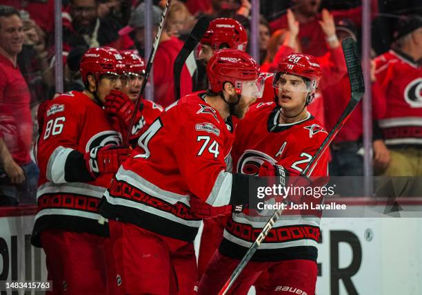 Jaccob Slavin of the Carolina Hurricanes celebrates with teammates after scoring a goal during the third period against the New York Islanders in...
