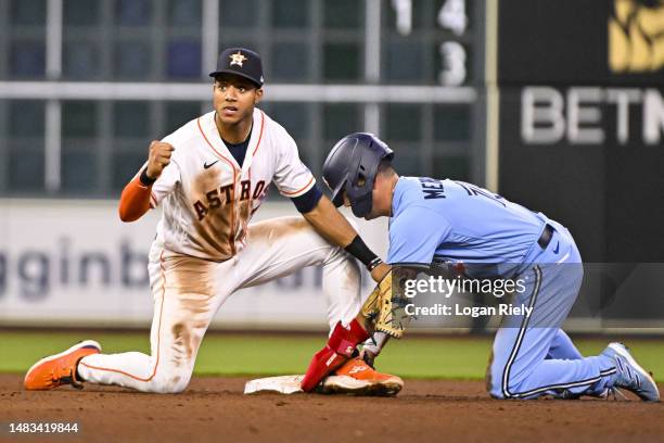 Jeremy Pena of the Houston Astros reacts to tagging out Whit Merrifield of the Toronto Blue Jays in the fifth inning at Minute Maid Park on April 19,...