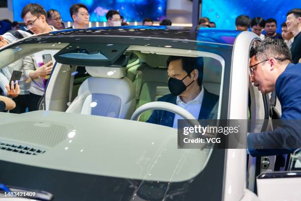 Lei Jun, Chairman of Xiaomi Technology, visits the booth of Rising Auto during the 20th Shanghai International Automobile Industry Exhibition at the...