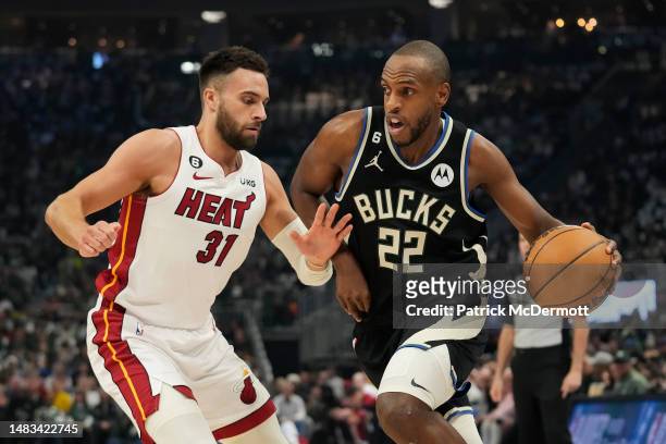 Khris Middleton of the Milwaukee Bucks dribbles the ball against Max Strus of the Miami Heat during the first half of Game Two of the Eastern...